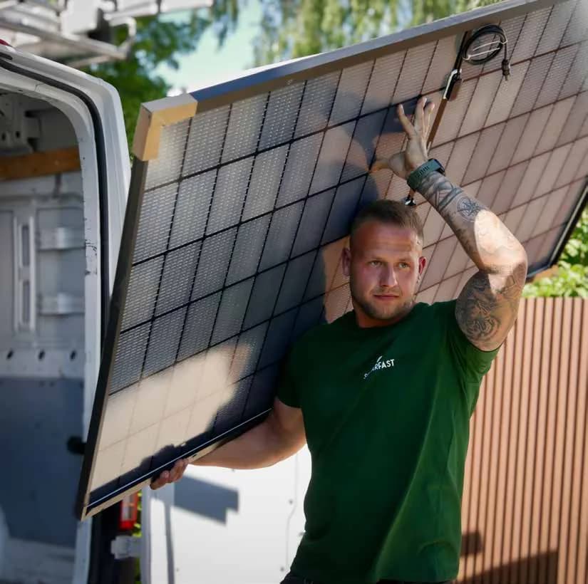 Installer carrying a solar panel