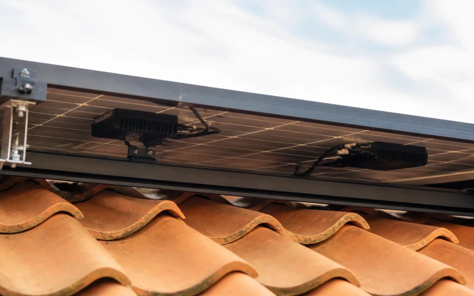 Rooftop solar panels with inverter hardware visible under the array