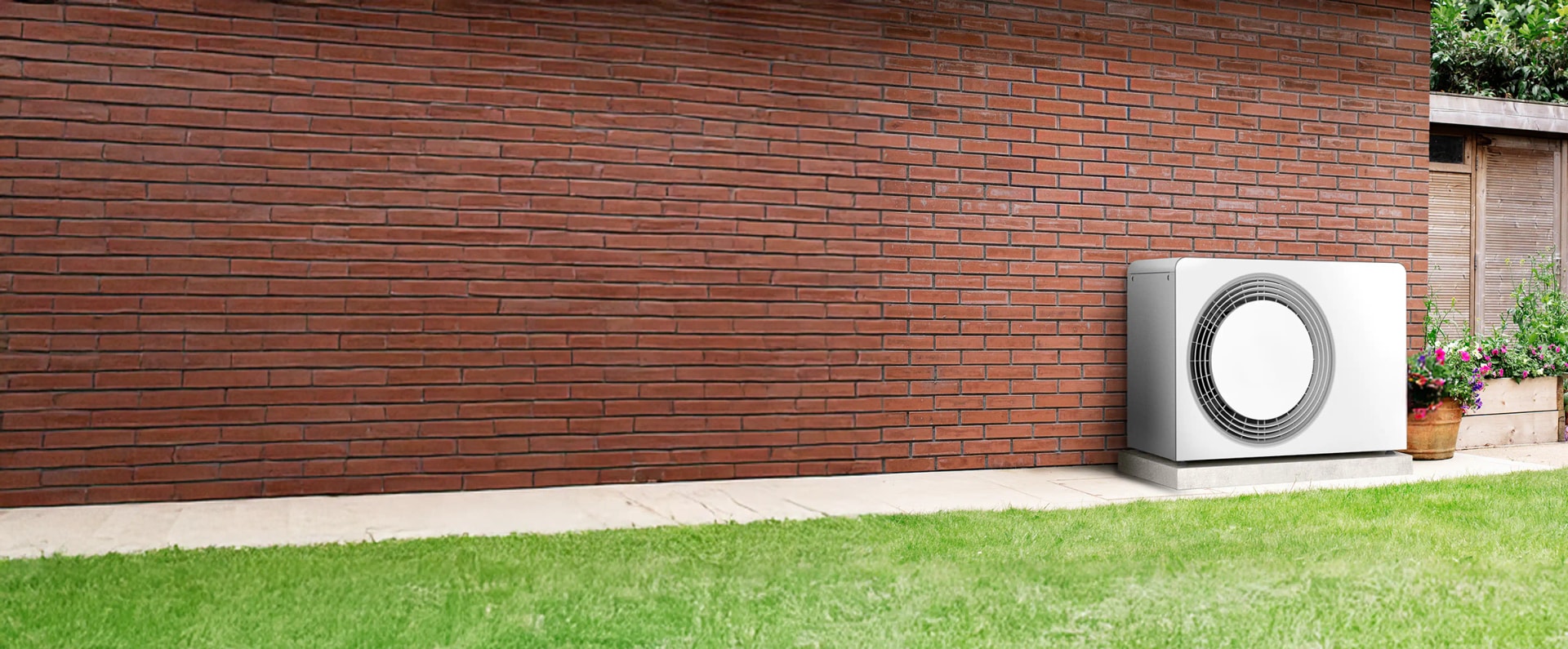 Heat pump against a brick wall