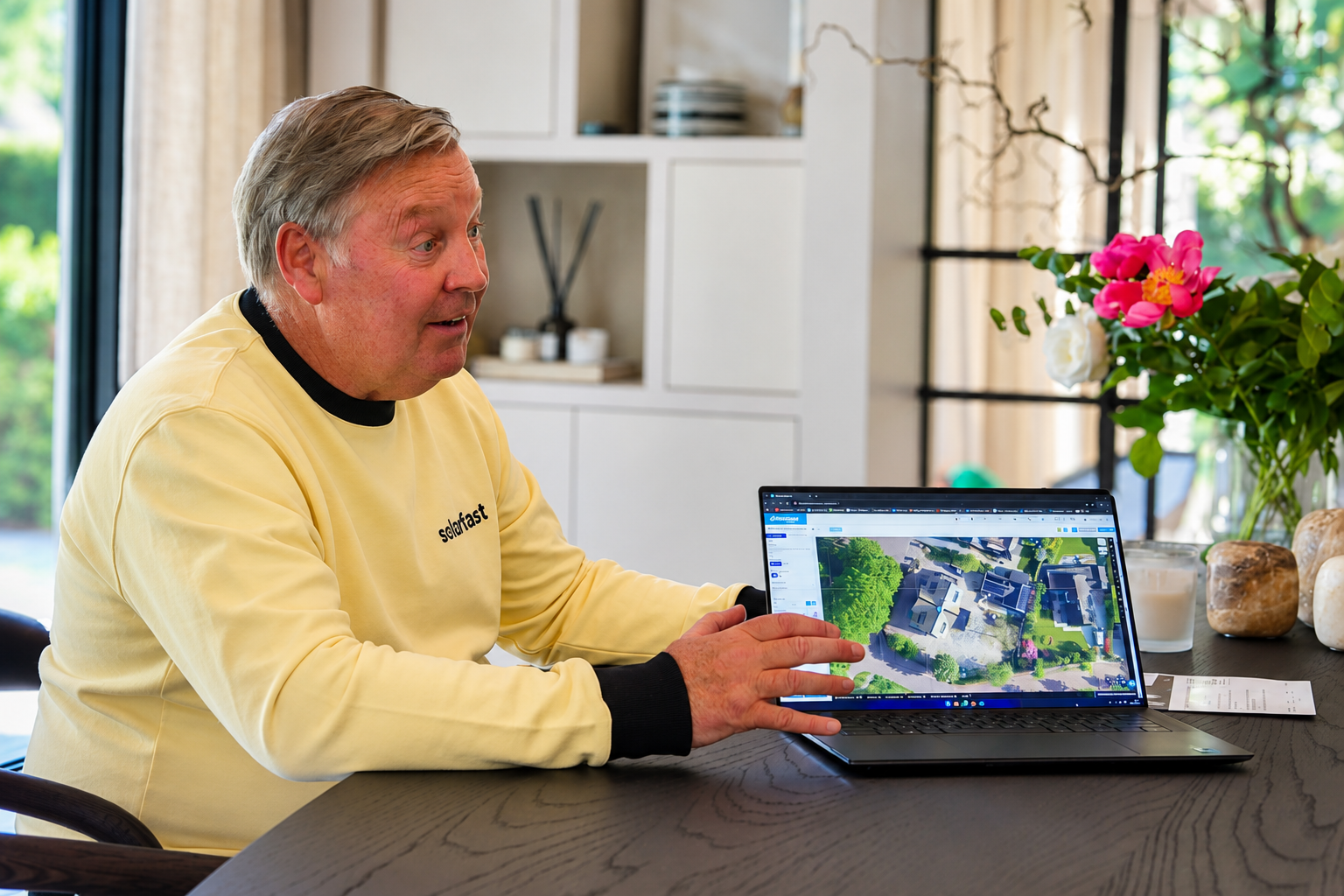 SolarFast adviser discussing the roof plan on a laptop at the table